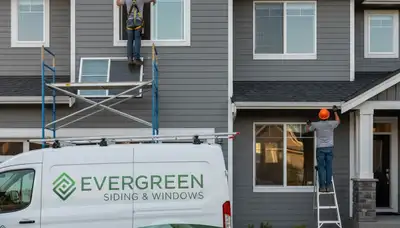 Technician repairing home window frame and vinyl siding in Spokane WA exterior service project